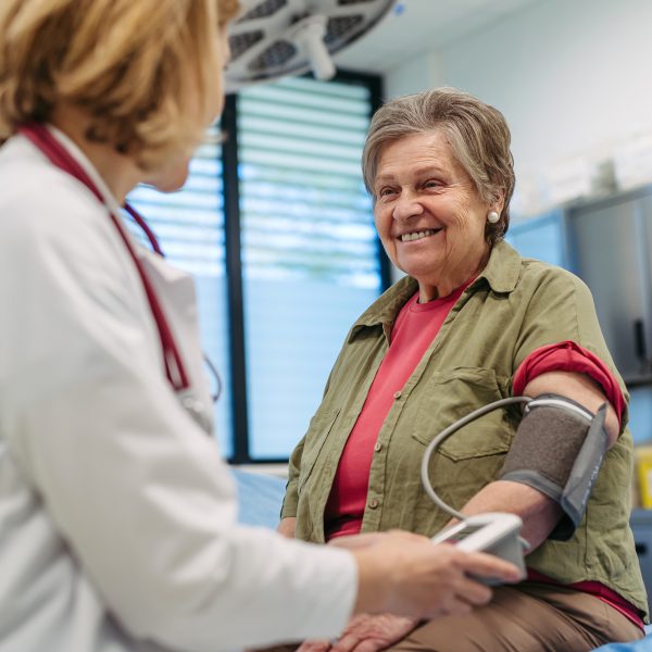 Senior woman having blood pressure checked, preventive care. Senior woman having blood pressure checked during preventive medical exam